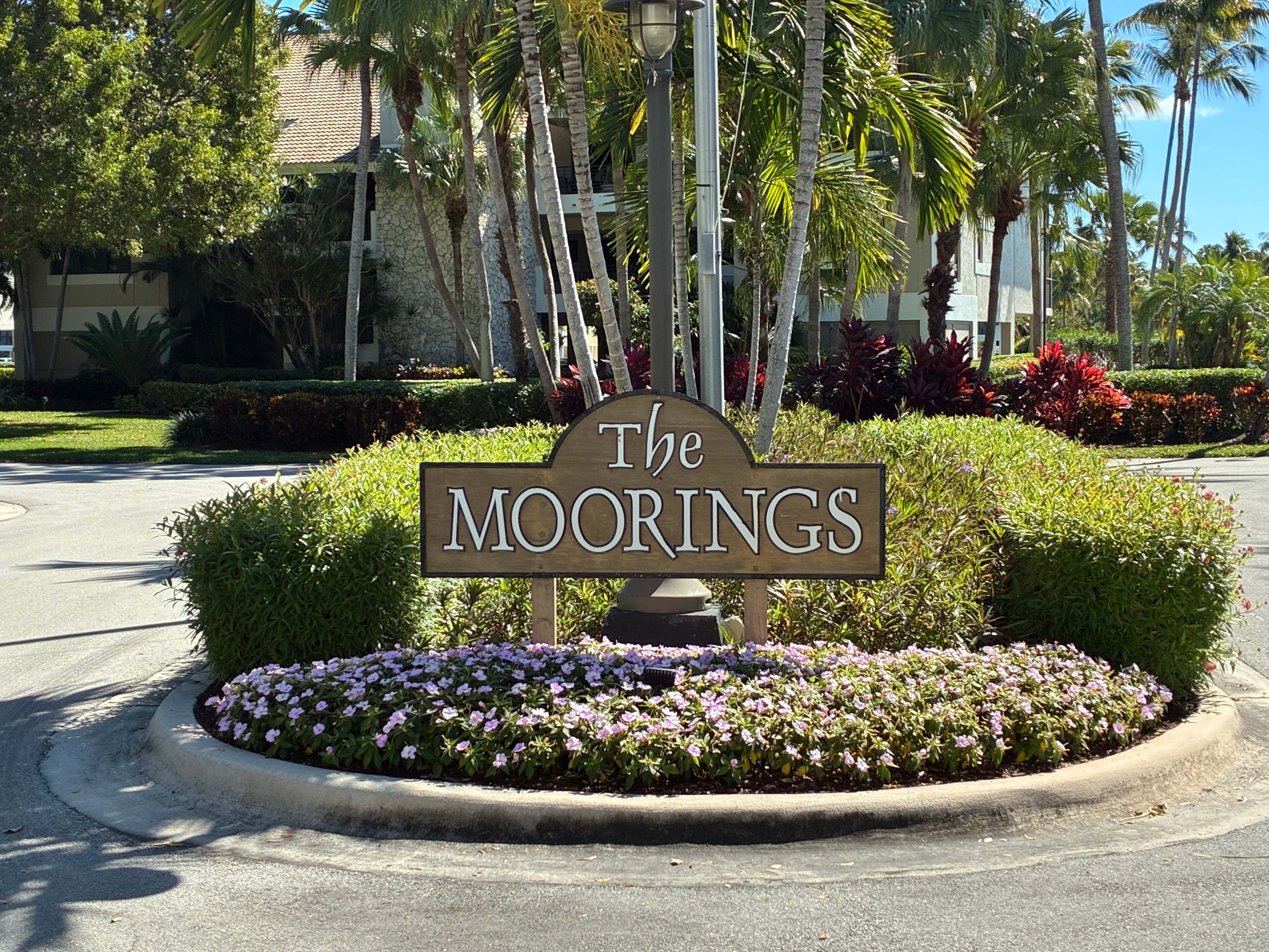 The Moorings neighborhood entrance with flower roundabout